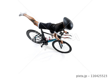 Female cyclist in professional gear and helmet sitting on road bike isolated on white background. 116425523