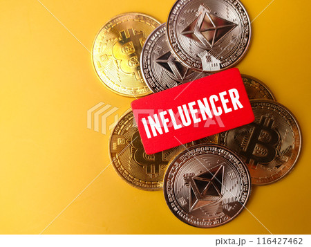 Top view colored board with text INFLUENCER and silver ethereum and golden bitcoin digital crypto coin on yellow background Top view colored board with text INFLUENCER and silver ethereum and golden bitcoin digital crypto coin on yellow background 116427462