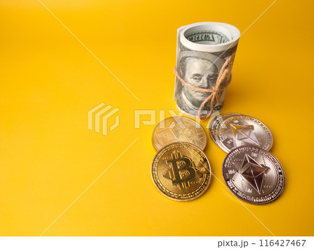 Banknotes with silver ethereum and golden bitcoin digital crypto coin on yellow background with copy space. Banknotes with silver ethereum and golden bitcoin digital crypto coin on yellow background with copy space. 116427467