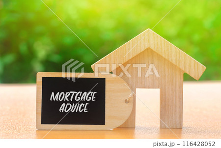 Mortgage advice concept. Professional guidance provided to help individuals choose, obtain, and manage home loans. Real estate. Wooden house with a note 116428052