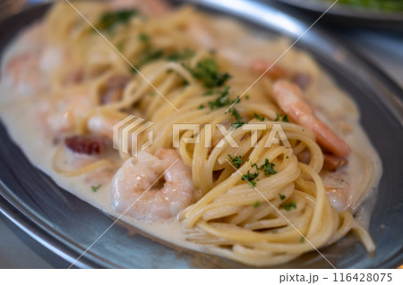 White wine cream sauce prawn and bacon pasta spaghetti served on plate 116428075