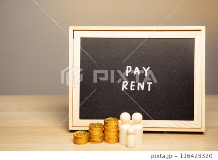 The concept of paying rent for housing, house or apartment. Accumulating money and saving. Miniature family standing near a board with the word Pay rent. 116428320