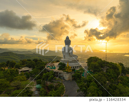 aerial view bright yellow sun at horizon in sunrise at Phuket big Buddha. aerial view bright yellow sun at horizon in sunrise at Phuket big Buddha. 116428334