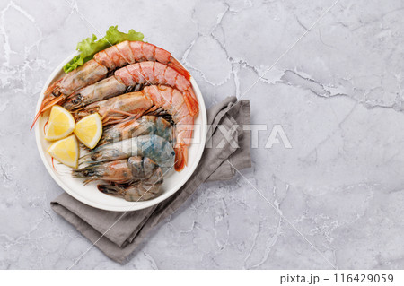 Raw shrimps on plate 116429059