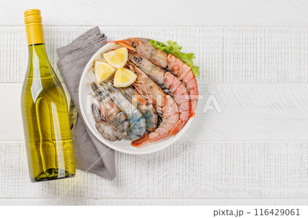 Raw shrimps on plate 116429061