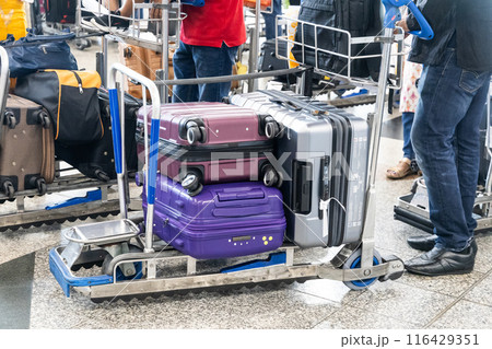 Luggages bags on trolley cart in airport departure terminal waiting for check-in 116429351