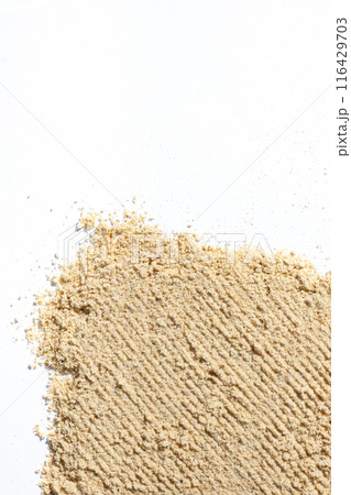 Ground dry ginger root on a white background, place for text Ground dry ginger root on a white background, place for text 116429703