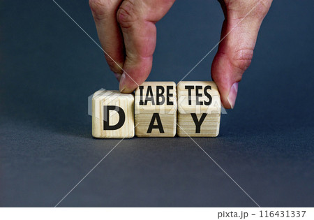 Diabetes day symbol. Concept words Diabetes day on wooden cubes. Doctor hand. Beautiful grey table grey background. Medical and Diabetes day concept. Copy space. 116431337