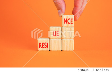 Resilience symbol. Concept word Resilience on beautiful wooden blocks. Businessman hand. Beautiful orange background. Business resilience concept. Copy space. Resilience symbol. Concept word Resilience on beautiful wooden blocks. Businessman hand. Beautiful orange background. Business resilience concept. Copy space. 116431339