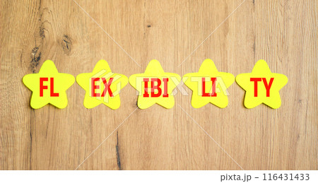 Flexibility symbol. Concept word Flexibility on beautiful yellow paper stars. Beautiful wooden background. Business flexibility concept. Copy space. Flexibility symbol. Concept word Flexibility on beautiful yellow paper stars. Beautiful wooden background. Business flexibility concept. Copy space. 116431433