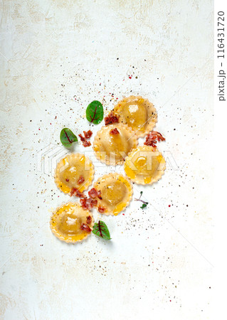fresh ravioli, with butter, spices and herbs, fried bacon, on the table, top view, light background, no people, fresh ravioli, with butter, spices and herbs, fried bacon, on the table, top view, light background, no people, 116431720