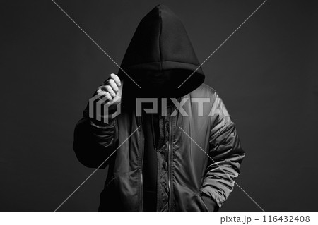Person in Black Hood. Boy in a hooded sweatshirt 116432408