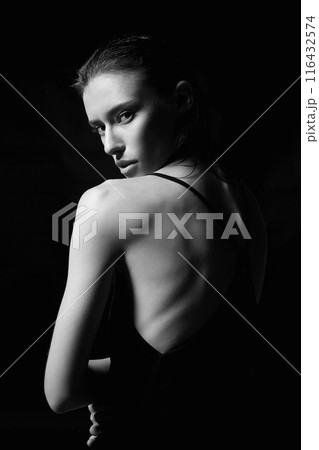 Beautiful sexy Girl in Dress with naked back. Black and white portrait 116432574