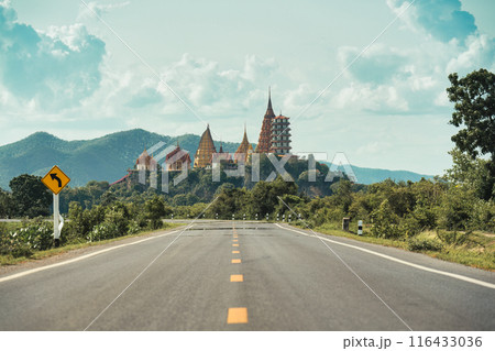 Rural road straight to Wat Tham Sua Temple on hill in Kanchanaburi 116433036