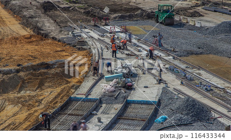 Repair works on the street timelapse. Laying of new tram rails on a city street 116433344