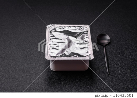 Rectangular plastic box with yogurt or cheese hermetically sealed with a foil lid 116433501