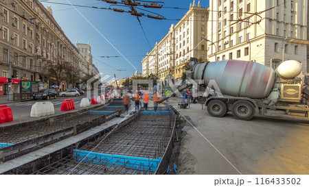 Concrete works for road maintenance construction with many workers and mixer machine timelapse 116433502