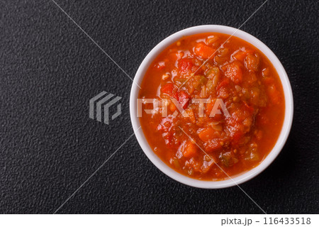 Red hot or spicy sauce with chili peppers, tomatoes, garlic, spices 116433518
