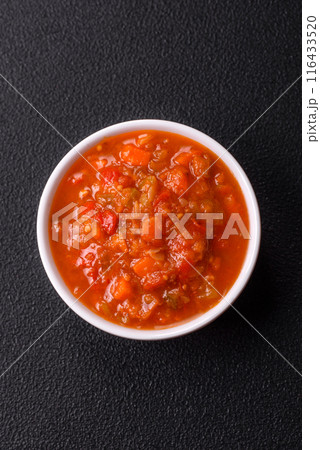 Red hot or spicy sauce with chili peppers, tomatoes, garlic, spices 116433520