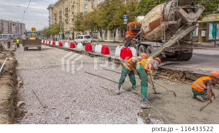 Concrete works for road maintenance construction with many workers and mixer machine timelapse 116433522