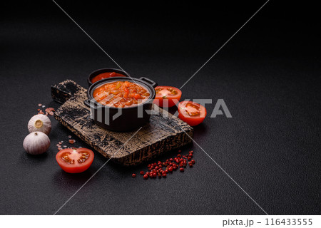 Red hot or spicy sauce with chili peppers, tomatoes, garlic, spices Red hot or spicy sauce with chili peppers, tomatoes, garlic, spices 116433555