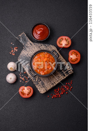 Red hot or spicy sauce with chili peppers, tomatoes, garlic, spices Red hot or spicy sauce with chili peppers, tomatoes, garlic, spices 116433559