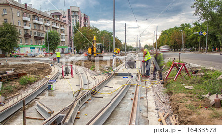 Workers install new tram rails during a reconstruction of the route timelapse. 116433578