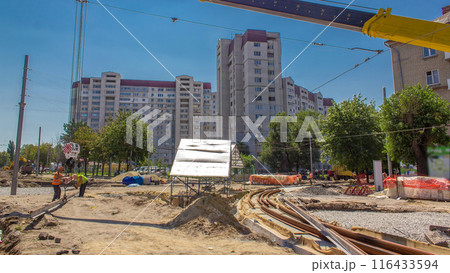 Yellow construction telescopic crane moving tram rails timelapse. Yellow construction telescopic crane moving tram rails timelapse. 116433594