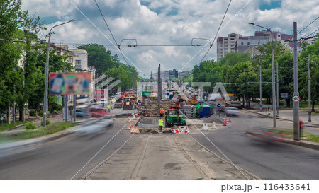 Road roller compacting stone during new road construction in preparation for tarmac timelapse 116433641