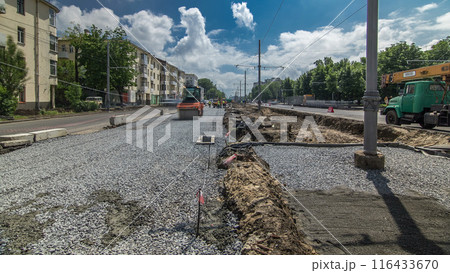 Orange vibration roller compactor rolls on a stones at road construction and repairing timelapse Orange vibration roller compactor rolls on a stones at road construction and repairing timelapse 116433670