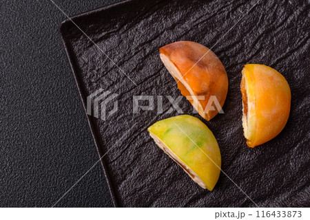 Delicious colorful asian mochi sweets with rice dough shell Delicious colorful asian mochi sweets with rice dough shell 116433873