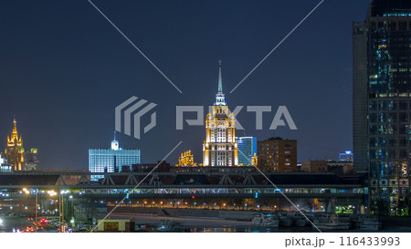 Hotel Ukraine and pedastrian bridge timelapse, landmark near historic center of Moscow. Cityscape in snowy winter evening. 116433993