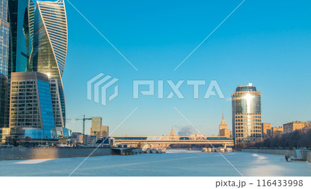 Moscow City skyscrapers and frozen river in winter at sunset timelapse. Moscow City skyscrapers and frozen river in winter at sunset timelapse. 116433998