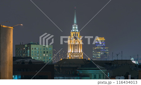 Hotel Ukraine with roofs timelapse, landmark near historic center of Moscow. Cityscape in snowy winter evening. 116434013