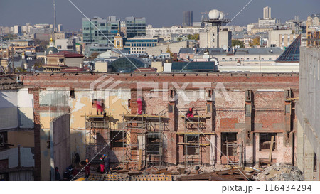 Bricklayers laying bricks to repair old walls timelapse. 116434294