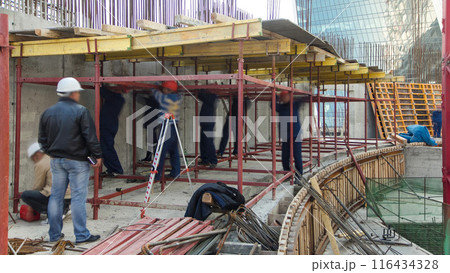 Construction workers working on steel rods used to reinforce concrete timelapse Construction workers working on steel rods used to reinforce concrete timelapse 116434328