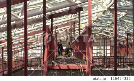 Welder working with electrode at semi-automatic arc welding in manufacture production plant timelapse 116434336