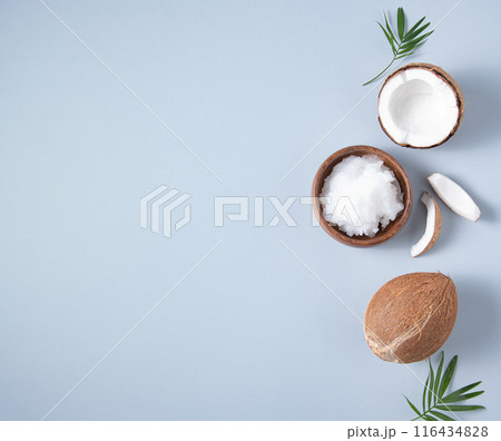 Concept healthy flat lay. Fresh coconut oil and coconut slices  on blue  background. Top view  Concept healthy flat lay. Fresh coconut oil and coconut slices  on blue  background. Top view  116434828