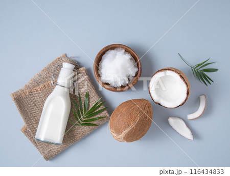Healthy flat lay concept. Vegan milk bottles, coconut oil,  coconut slices and palm branch 116434833