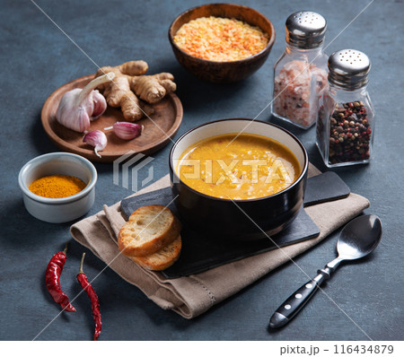 Traditional Indian soup dal masala of lentils with spicy curry in a bowl with spices and herbs 116434879
