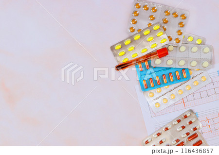 After examining electrocardiogram, cardiologist prescribe necessary medication for treatment of heart diseases After examining electrocardiogram, cardiologist prescribe necessary medication for treatment of heart diseases 116436857