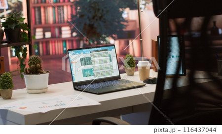 Empty home setup belonging to an entrepreneur with data sales analytics and financial reports on laptop, accountancy information and invoices for remote work. Finance and economy. Empty home setup belonging to an entrepreneur with data sales analytics and financial reports on laptop, accountancy information and invoices for remote work. Finance and economy. 116437044