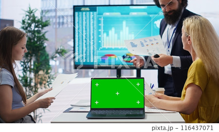 Financial adviser doing presentation on isolated screen laptop to help clients build saving habits, close up. Agent using chroma key notebook to show customers investing tips, camera B 116437071