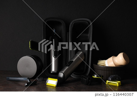 Men's shaving tools in case and cosmetic jar on dark background Men's shaving tools in case and cosmetic jar on dark background 116440307