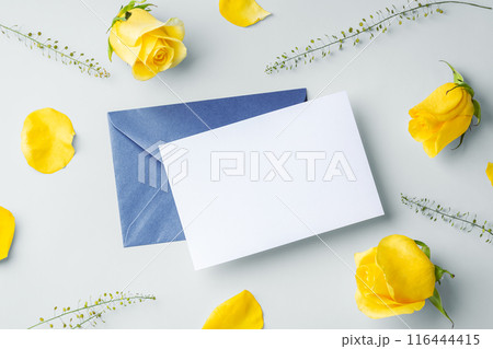 White card and blue envelope with yellow roses, father's day card, top view White card and blue envelope with yellow roses, father's day card, top view 116444415
