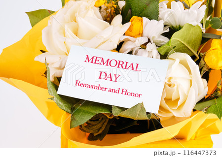 Memorial Day Remember and Honor text written in a bouquet with flowers on a white card Memorial Day Remember and Honor text written in a bouquet with flowers on a white card 116447373