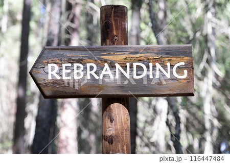 Business and rebrand concept. Copy space. REBRANDING symbol on a wooden signpost against a forest background 116447484
