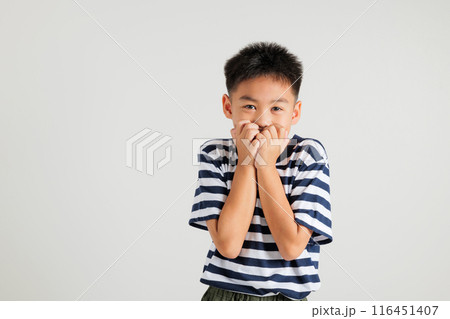 Asian portrait cute young kid boy standing amazed, shocked afraid mouth covered gesturing hand palms looking camera, studio shot isolated on white background, Thai primary child scared Asian portrait cute young kid boy standing amazed, shocked afraid mouth covered gesturing hand palms looking camera, studio shot isolated on white background, Thai primary child scared 116451407