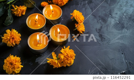 Top view of Orange marigold flowers with yellow candles on dark background, symbolizing the Day of the Dead celebration. Perfect for cultural and festive themes. Holiday banner with copy space 116452291