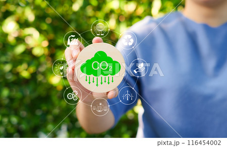 Carbon footprint concept. Carbon emissions, net zero carbon neutral. Woman holding carbon reduction icon. CO2 neutrality, Sustainable, Climate change, Global warming, Greenhouse gas, Renewable energy, 116454002